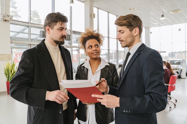 three people reading over a lease agreement